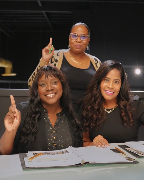 Three agents celebrating together at a table